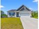 Charming single-Gathering home featuring well-manicured lawn, attached two car garage, and welcoming curb appeal at 127 Emerald Rush Ct., Longs, SC 29568