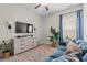 Cozy living room with a plush sofa, TV, and plants creating a relaxing atmosphere at 127 Emerald Rush Ct., Longs, SC 29568