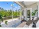 Relaxing screened porch with comfortable seating and scenic views of the trees and waterfront at 127 Emerald Rush Ct., Longs, SC 29568