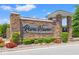 Stone entrance signage for River Haven community with lush manicured landscaping and accent flower beds at 127 Emerald Rush Ct., Longs, SC 29568