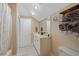 A clean bathroom includes a double sink vanity, framed mirror, and a storage rack with rolled towels at 130 Pier Pointe Dr., Little River, SC 29566