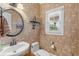 Charming powder room with stylish wallpaper, round mirror, and a pedestal sink for guests at 130 Pier Pointe Dr., Little River, SC 29566