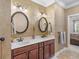 A bathroom vanity with double sinks and a framed mirror are complemented by stylish wallpaper at 130 Pier Pointe Dr., Little River, SC 29566