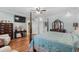 Primary bedroom with four-poster bed, dresser, and closet access at 130 Pier Pointe Dr., Little River, SC 29566
