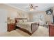 Comfortable bedroom features a ceiling fan, french doors, a wall-mounted TV, and neutral carpeting at 130 Pier Pointe Dr., Little River, SC 29566