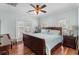 Comfortable bedroom with a ceiling fan, hardwood floors, and double doors to outside at 130 Pier Pointe Dr., Little River, SC 29566