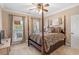 Elegant bedroom suite features a four-poster bed, neutral walls, and windows to a private balcony at 130 Pier Pointe Dr., Little River, SC 29566