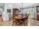 Elegant dining room with wood table, chairs, hutch, and natural light from the windows at 130 Pier Pointe Dr., Little River, SC 29566