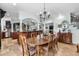 Open floor plan dining room with wood table, chairs, and view to the kitchen at 130 Pier Pointe Dr., Little River, SC 29566