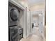 A laundry area with a stackable washer and dryer setup near a barn door to another room at 130 Pier Pointe Dr., Little River, SC 29566