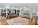 Spacious living room featuring hardwood floors, a large rug, and a view into the kitchen at 130 Pier Pointe Dr., Little River, SC 29566