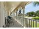 Enjoy relaxing moments on the charming covered porch, overlooking the neighborhood's picturesque surroundings at 130 Pier Pointe Dr., Little River, SC 29566