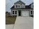 Charming home featuring gray siding, black roof, and a one-car attached garage at 1307 American Shad Dr. # 47, Conway, SC 29526