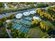 Aerial view showcasing tennis courts, waterways, and lush landscaping near luxury residences at 1330 Villa Marbella Ct. # 3-105, Myrtle Beach, SC 29572