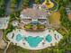 Stunning aerial view of a large building with pools, palm trees, and meticulously manicured landscaping and parking at 1330 Villa Marbella Ct. # 3-105, Myrtle Beach, SC 29572