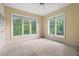 Bright, empty bedroom with hardwood floors, large windows with blinds, and fresh paint throughout at 1330 Villa Marbella Ct. # 3-105, Myrtle Beach, SC 29572