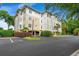 Condominium's exterior elevation with covered parking and lush landscaping at 1330 Villa Marbella Ct. # 3-105, Myrtle Beach, SC 29572