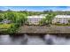 Exterior view of condos on the water with manicured landscaping, a riverfront view, and a blue sky at 1330 Villa Marbella Ct. # 3-105, Myrtle Beach, SC 29572