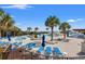 Beautiful pool area with palm trees, lounge chairs, and a jacuzzi perfect for relaxation at 1330 Villa Marbella Ct. # 3-105, Myrtle Beach, SC 29572