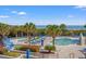 Inviting pool deck area with lounge chairs and palm trees and ocean views at 1330 Villa Marbella Ct. # 3-105, Myrtle Beach, SC 29572