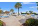 Relaxing pool deck with lounge chairs, palm trees, and well-maintained landscaping at 1330 Villa Marbella Ct. # 3-105, Myrtle Beach, SC 29572
