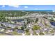 Aerial view of community homes, pond, and landscape near the ocean at 1391 Turkey Ridge Rd. # C, Surfside Beach, SC 29575