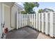 Private backyard area featuring a brick patio, white picket fence, and green foliage at 1391 Turkey Ridge Rd. # C, Surfside Beach, SC 29575
