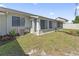 Exterior view of the home's backyard, sunroom, lawn, and plants at 1391 Turkey Ridge Rd. # C, Surfside Beach, SC 29575