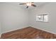 Cozy bedroom features hardwood floors, a ceiling fan, and pass through to kitchen at 1391 Turkey Ridge Rd. # C, Surfside Beach, SC 29575