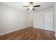 Bedroom featuring wood-look floors and an adjacent bathroom at 1391 Turkey Ridge Rd. # C, Surfside Beach, SC 29575