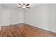 Bright bedroom featuring wood-look floors, ceiling fan, and neutral walls at 1391 Turkey Ridge Rd. # C, Surfside Beach, SC 29575