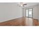 Bedroom with hardwood flooring, sliding doors, and a ceiling fan at 1391 Turkey Ridge Rd. # C, Surfside Beach, SC 29575