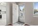 Bright foyer featuring a white door, a welcome mat, and a view into the updated kitchen at 1391 Turkey Ridge Rd. # C, Surfside Beach, SC 29575