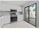Updated kitchen with white cabinets, stainless steel appliances, and a sliding door to the patio at 1391 Turkey Ridge Rd. # C, Surfside Beach, SC 29575
