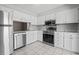 Beautiful kitchen featuring white cabinets, stainless steel appliances, and tile flooring at 1391 Turkey Ridge Rd. # C, Surfside Beach, SC 29575
