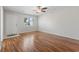 Spacious living room featuring gleaming hardwood floors, a ceiling fan, and lots of natural light at 1391 Turkey Ridge Rd. # C, Surfside Beach, SC 29575