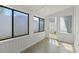 Sunroom with tile floor, bead board paneling, large windows, and a glass door at 1391 Turkey Ridge Rd. # C, Surfside Beach, SC 29575