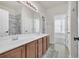 Bathroom featuring double sinks, vanity, and a shower with marble at 140 Zinnia Dr., Myrtle Beach, SC 29579