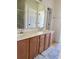 Bathroom featuring double sinks with a marble countertop, and white vanities at 140 Zinnia Dr., Myrtle Beach, SC 29579