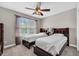 Neutral bedroom with two twin beds, featuring a dark wooden bed frame and a ceiling fan at 140 Zinnia Dr., Myrtle Beach, SC 29579
