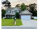 Charming two-story home with a well-manicured lawn, brick accents, and a two-car garage at 140 Zinnia Dr., Myrtle Beach, SC 29579