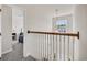 Upstairs hallway featuring white wooden railings and a hanging pendant light at 140 Zinnia Dr., Myrtle Beach, SC 29579