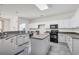 Updated kitchen with white cabinets, dark countertops, stainless steel appliances, and tile flooring at 140 Zinnia Dr., Myrtle Beach, SC 29579