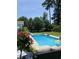 Inviting in-ground pool with clear blue water, surrounded by a patio, landscaping, and outdoor seating at 140 Zinnia Dr., Myrtle Beach, SC 29579
