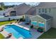 Aerial view of a refreshing pool, surrounded by outdoor seating and a covered patio, perfect for entertaining guests at 140 Zinnia Dr., Myrtle Beach, SC 29579