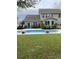 Backyard oasis featuring a sparkling blue pool surrounded by lush greenery and potted plants at 140 Zinnia Dr., Myrtle Beach, SC 29579