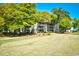 Apartment building exterior with lush green surroundings and mature trees providing shade at 1401 Lighthouse Dr. # 4226, North Myrtle Beach, SC 29582