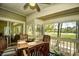 Cozy screened-in patio with wood table and chairs, offering beautiful views of the surrounding landscape at 1401 Lighthouse Dr. # 4226, North Myrtle Beach, SC 29582