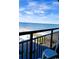 Stunning ocean view from the balcony, overlooking beach, parked cars, and a railing at 1501 S Ocean Blvd. # 1009, Myrtle Beach, SC 29577