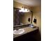 Traditional bathroom featuring a granite countertop and decorative mirror at 1501 S Ocean Blvd. # 1009, Myrtle Beach, SC 29577